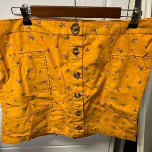 Yellow corduroy style skirt with floral pattern
